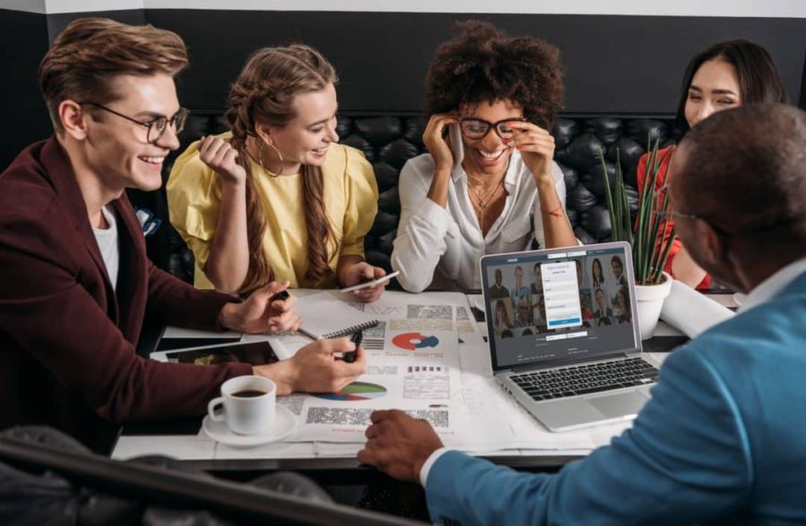 young group of business colleagues working together in cafe